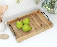 Wooden tray with green apples on a white surface
