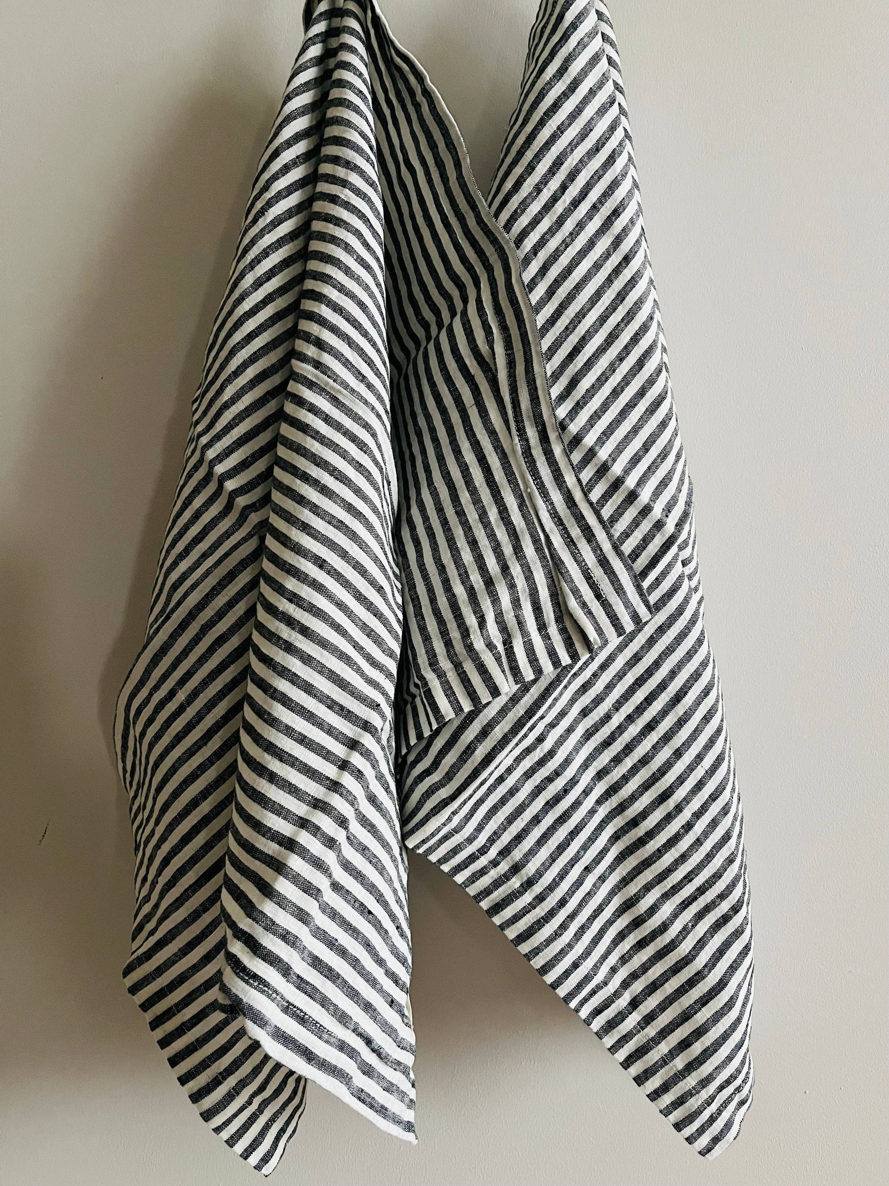Black and white striped towel on a plain background