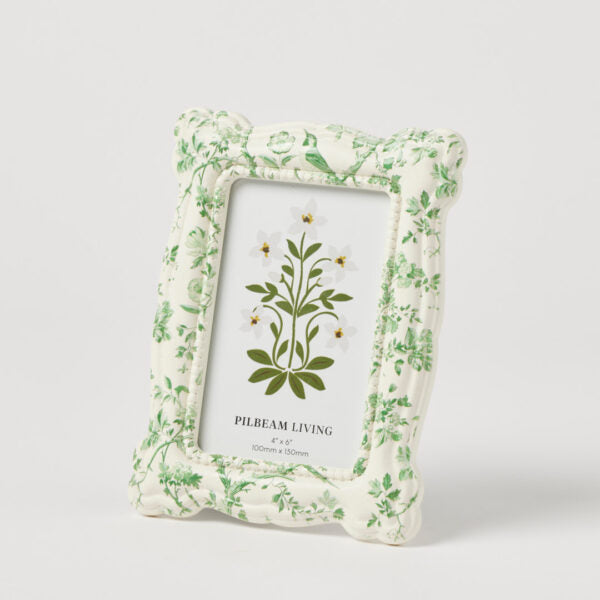 Floral patterned picture frame with a plant illustration on a white background