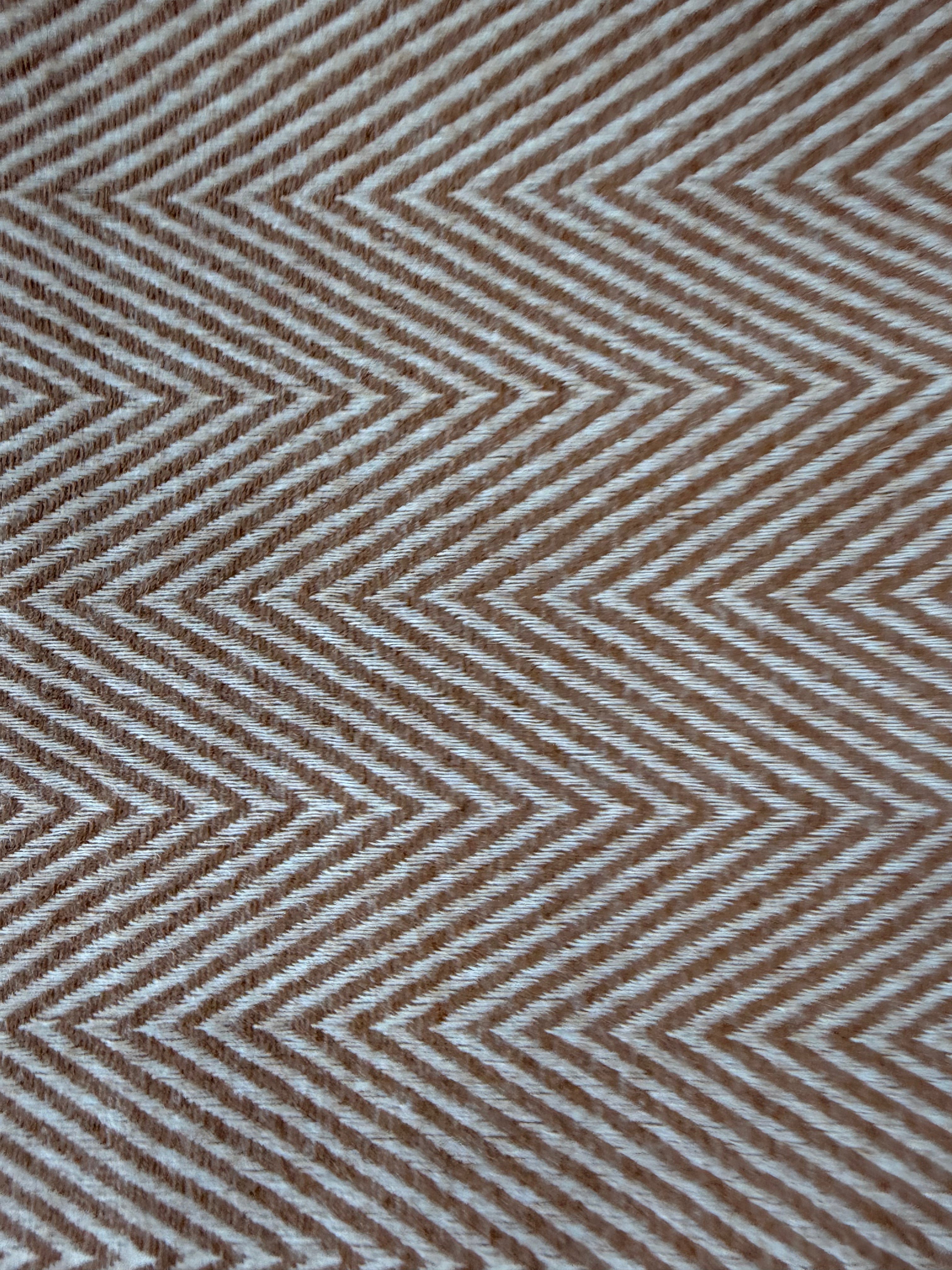 Close-up of a brown and beige zigzag patterned fabric.