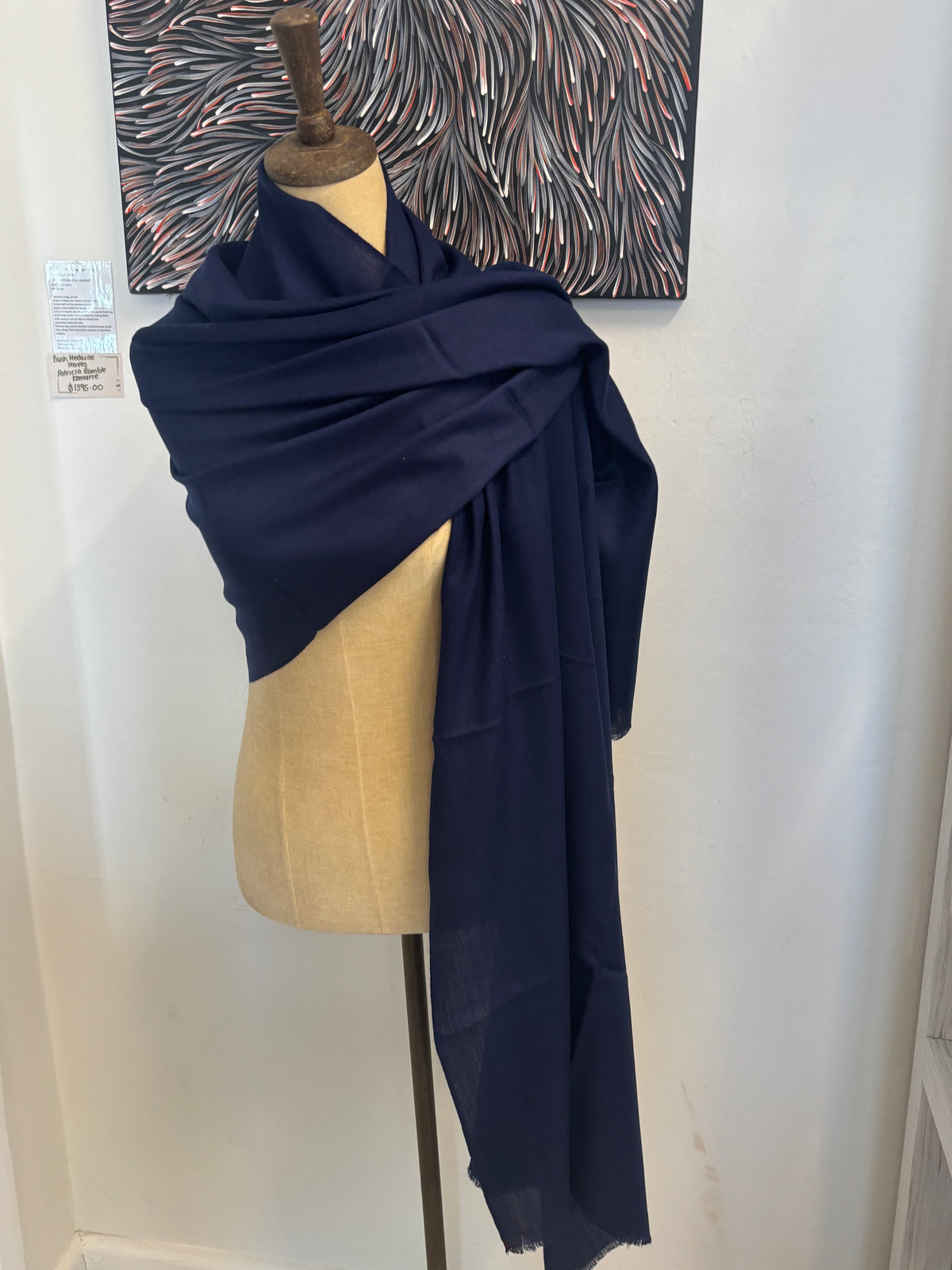 Navy blue fabric on a mannequin with a white background