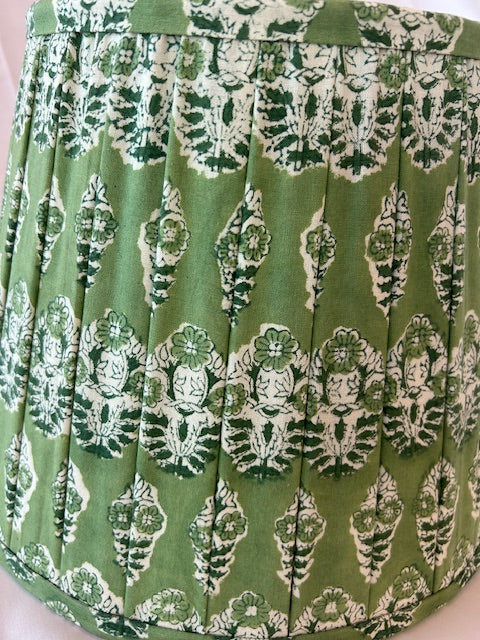 Green fabric with white floral patterns, folded and displayed.