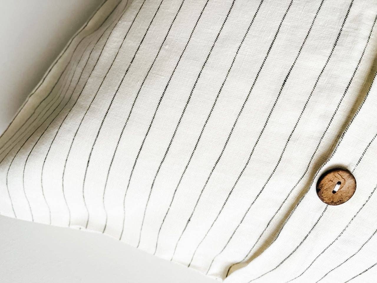 Close-up of a button on a piece of striped fabric
