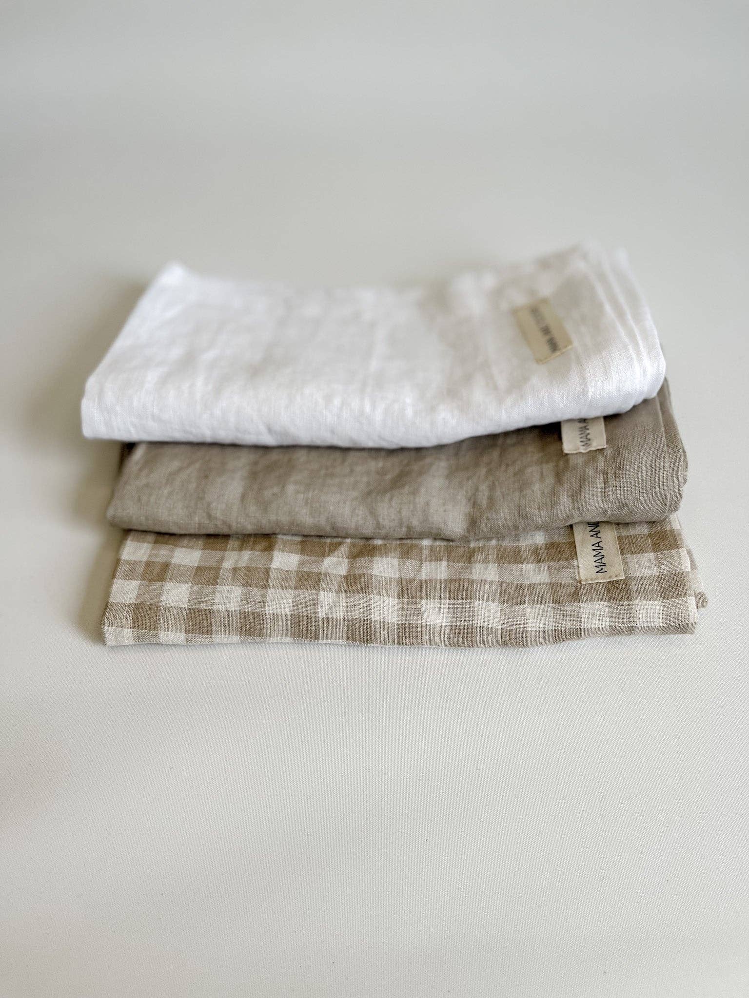Stack of folded fabric swatches on a light gray background