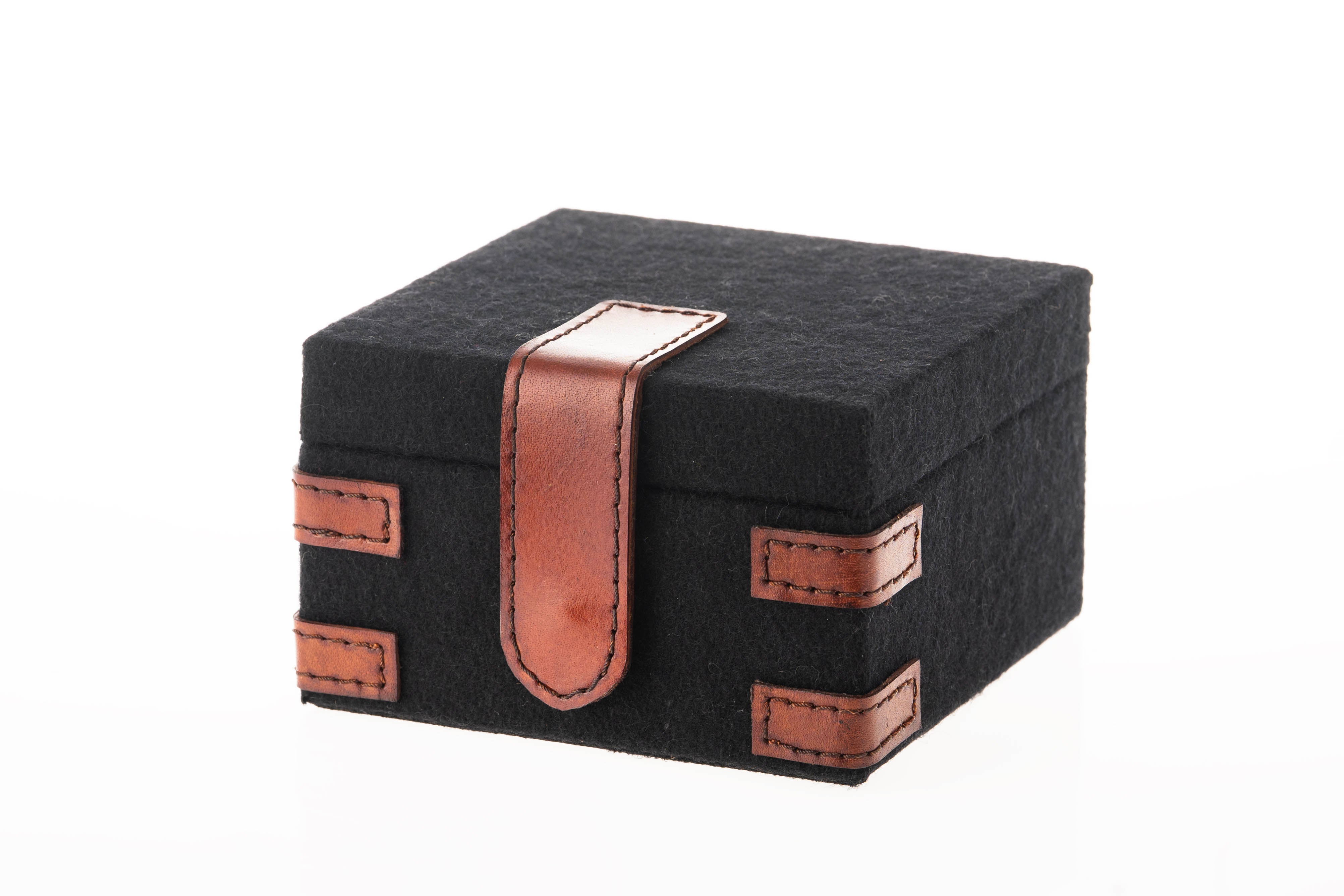 Black felt box with brown leather straps on a white background