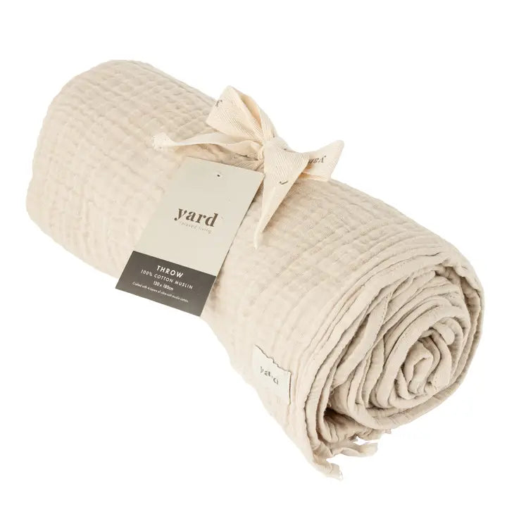 Beige throw blanket with a 'yard' tag on a white background