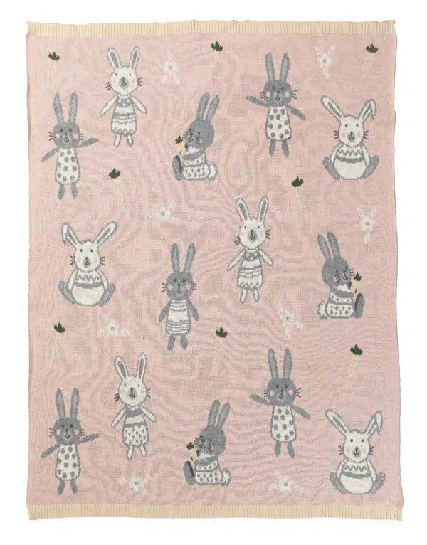 Pink blanket with cartoon rabbit pattern on a white background