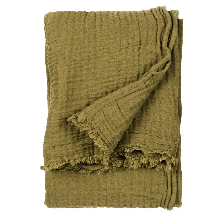 Folded green textured fabric on a white background