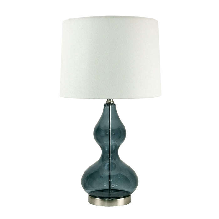 Table lamp with a dark blue glass base and white shade on a white background