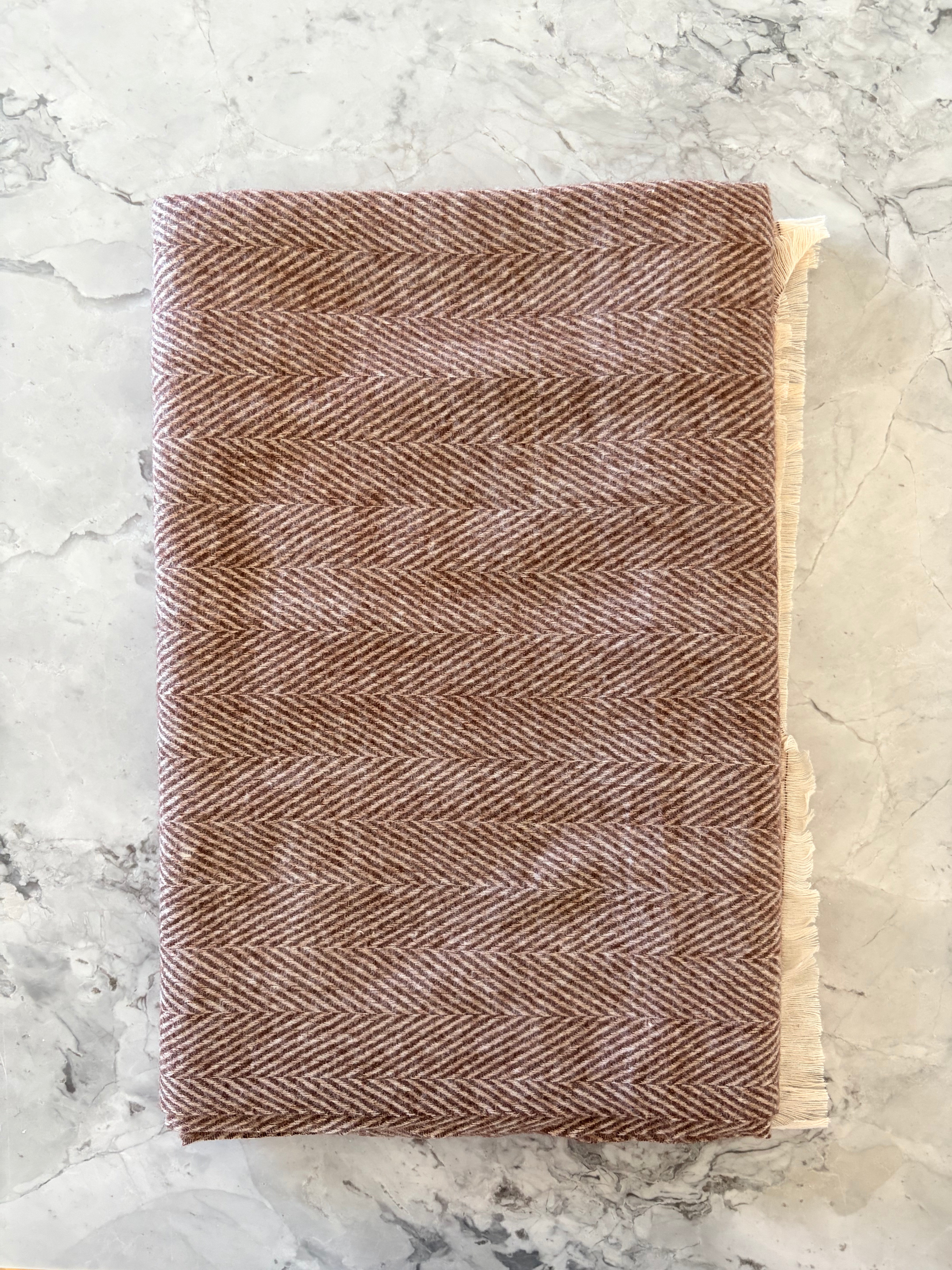 Brown and white scarf on a marble surface