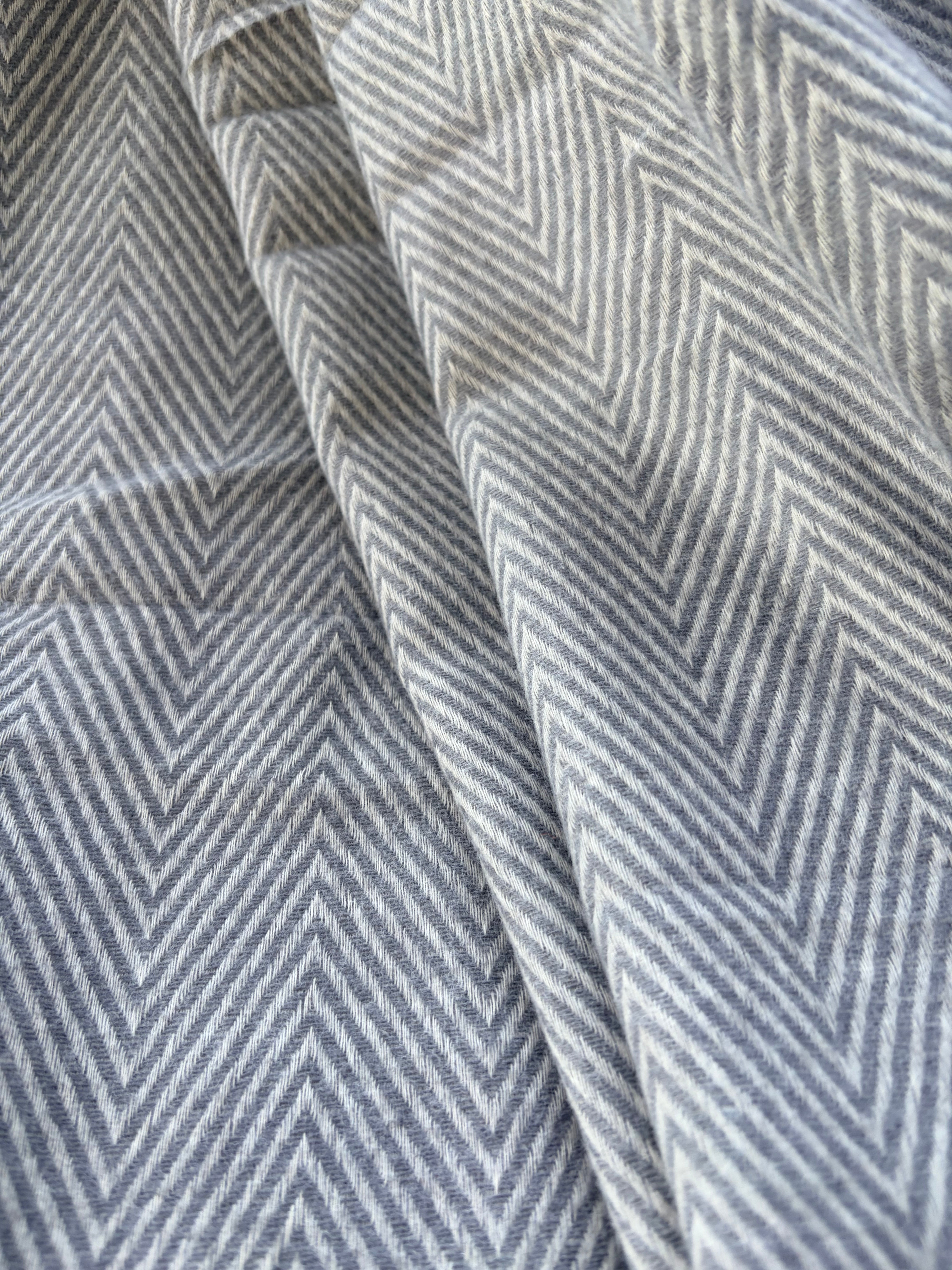Close-up of fabric with a zigzag pattern in gray and white.