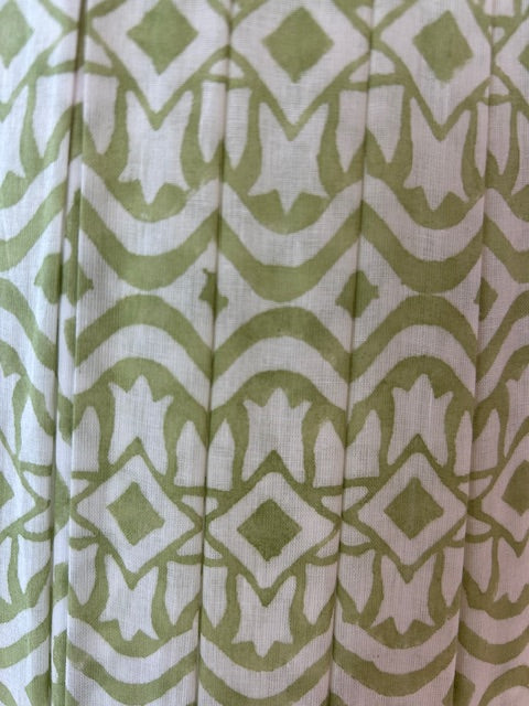 Folded fabric with green and white geometric pattern