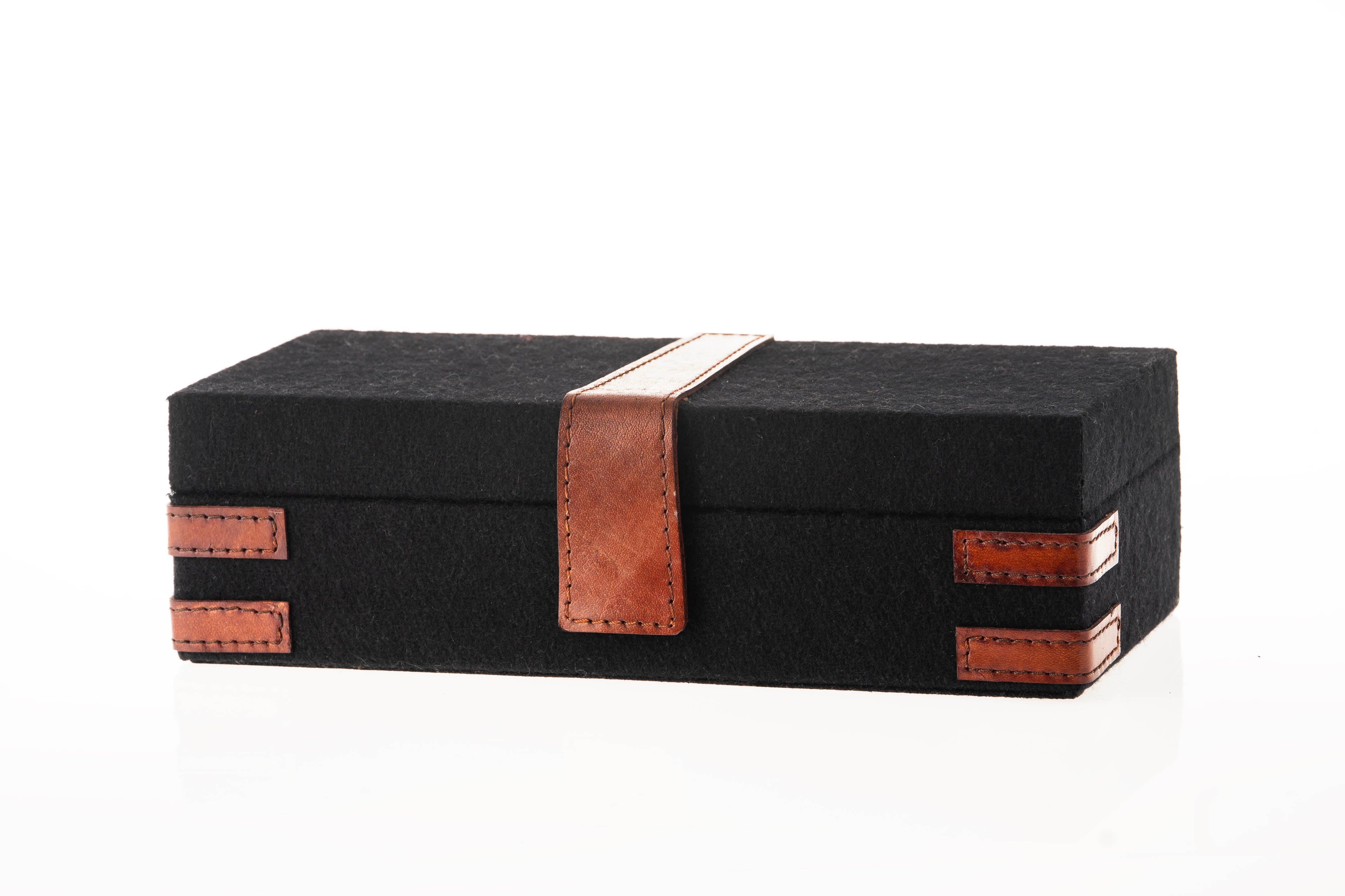 Black felt box  with brown leather straps on a white background