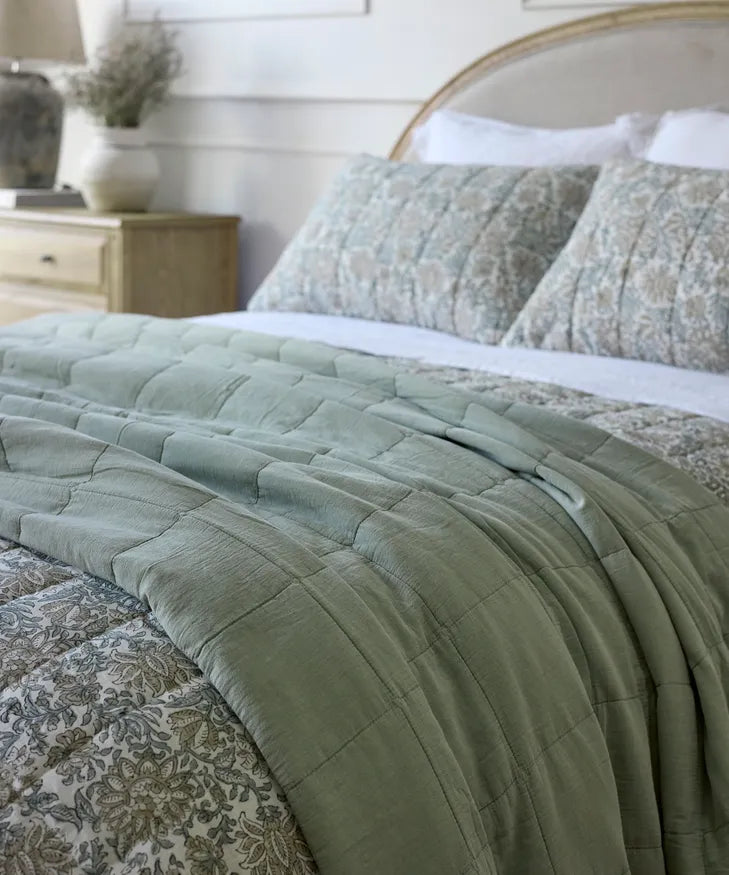 Bed with sage green quilt