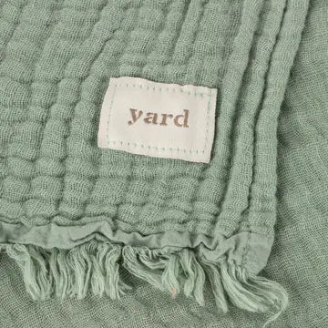 Green textured fabric with a 'yard' label