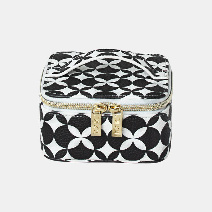Black and white geometric patterned travel case with gold zipper on a light gray background