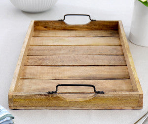 Wooden tray with handles on a light background